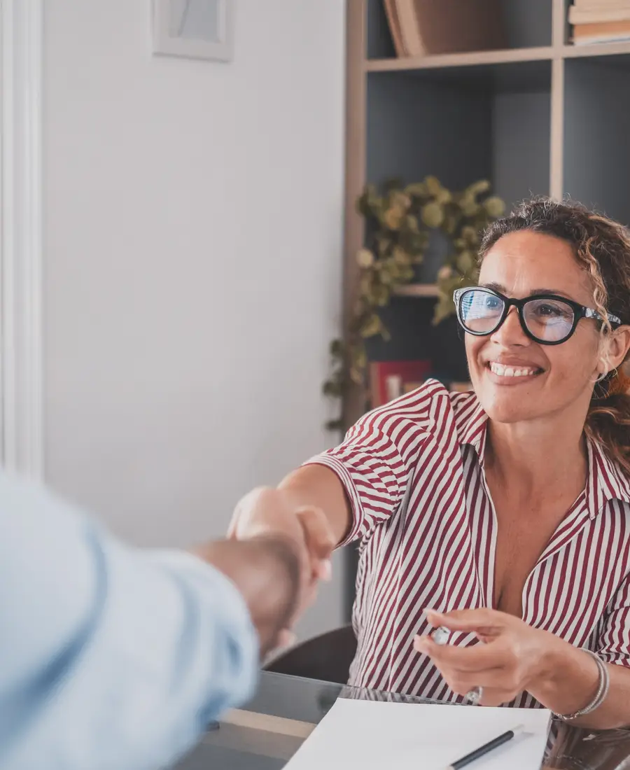 An agent shaking hands with a client